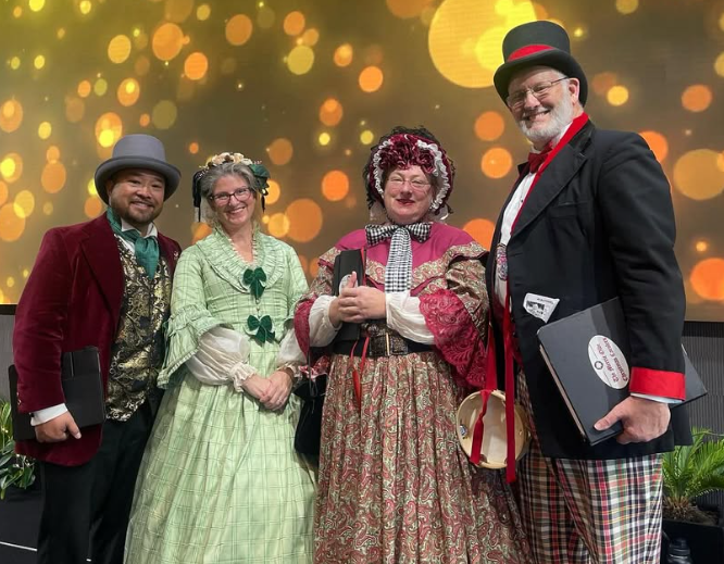 Photo of the Merrie Olde Christmas Carolers - Two men and two women in Dickensian clothes