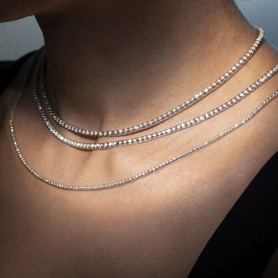 Image of a woman's neck with three diamond necklaces