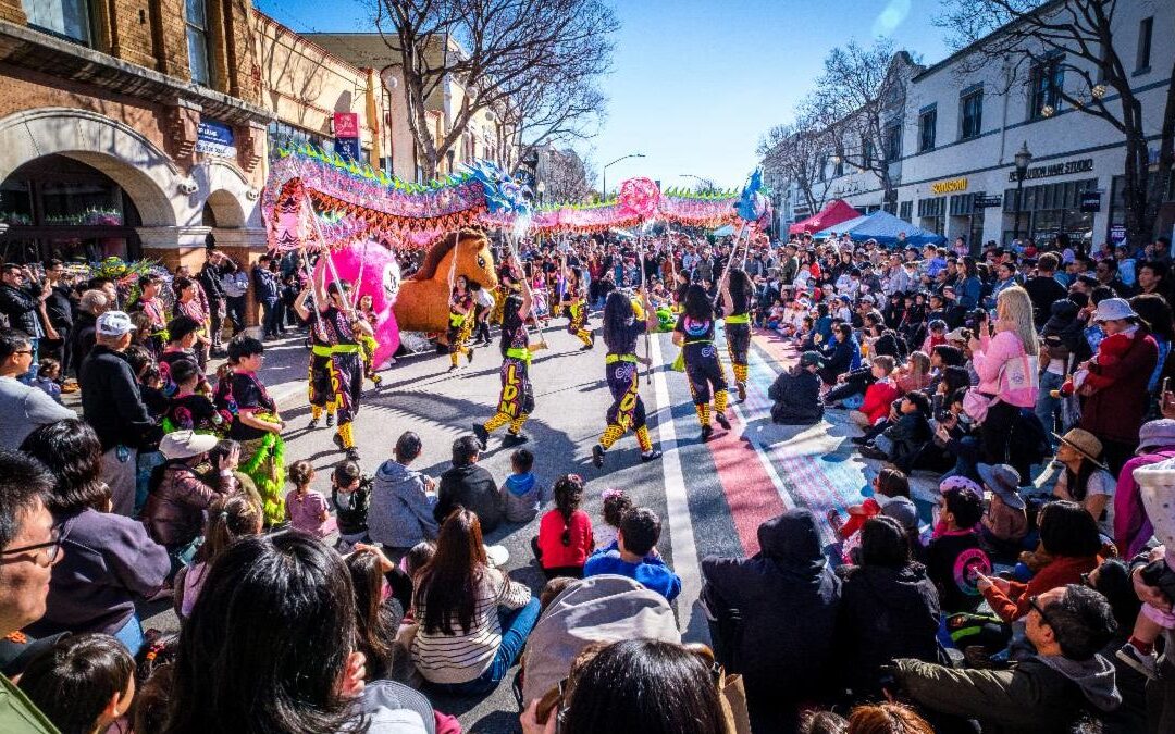 Photo of a crowd watching dragon dancers on B Street on a sunny day